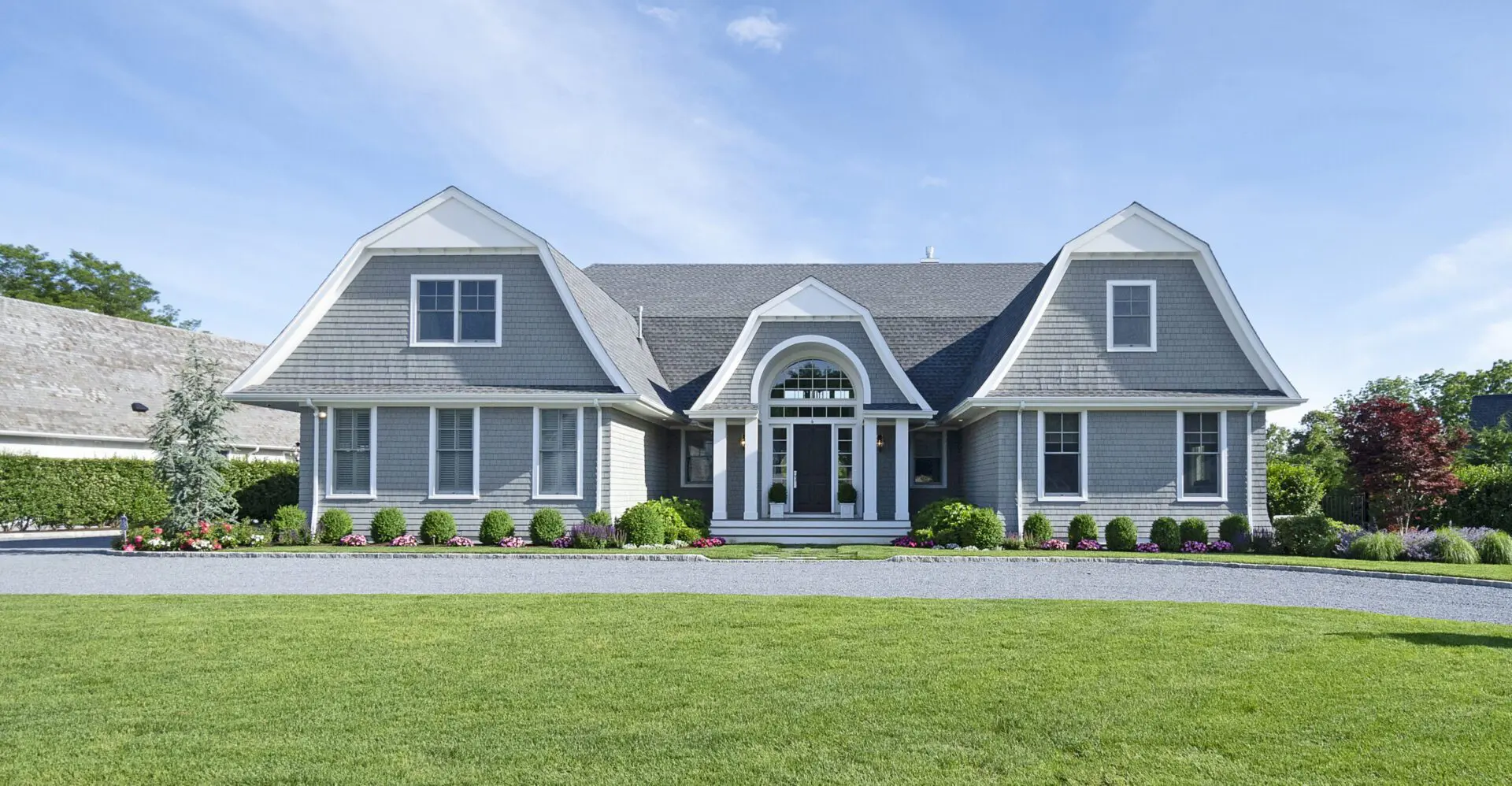 A large house with a lawn in front of it.