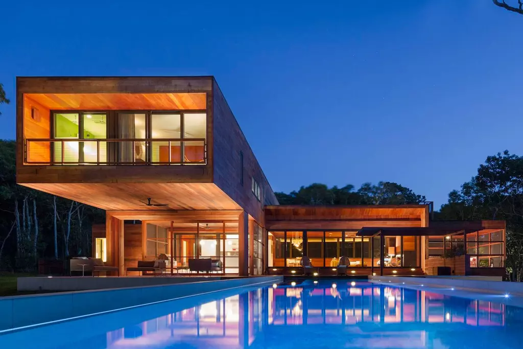 A large pool with a house in the background